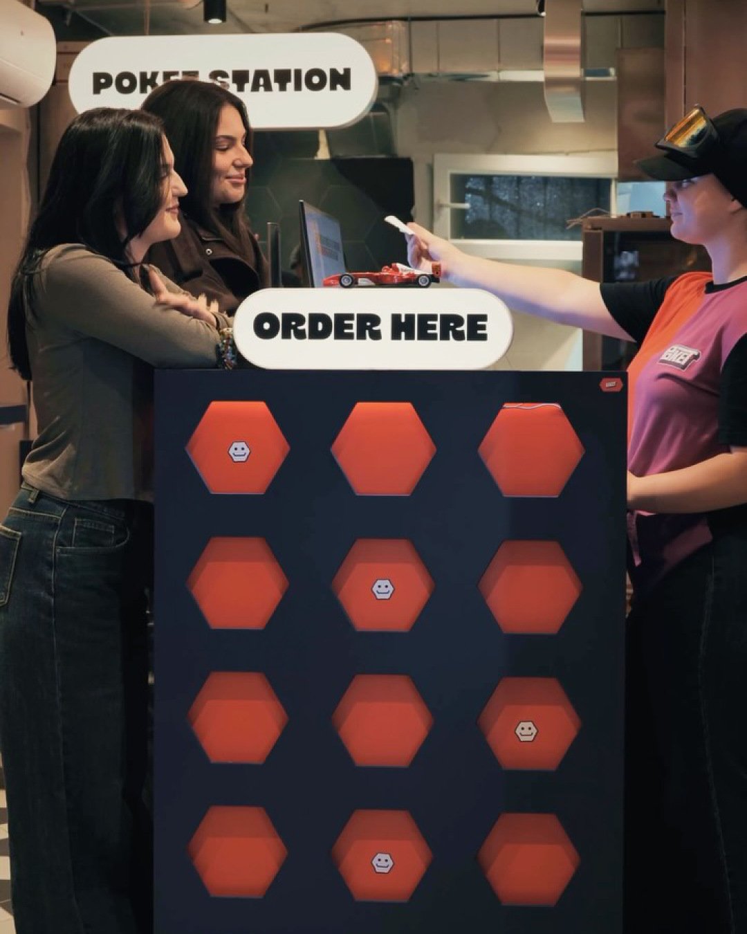 Customers ordering at the POKET Station counter.