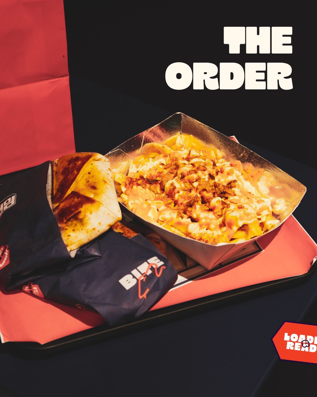 The Order campaign showing a filled wrap and loaded fries on a branded tray.